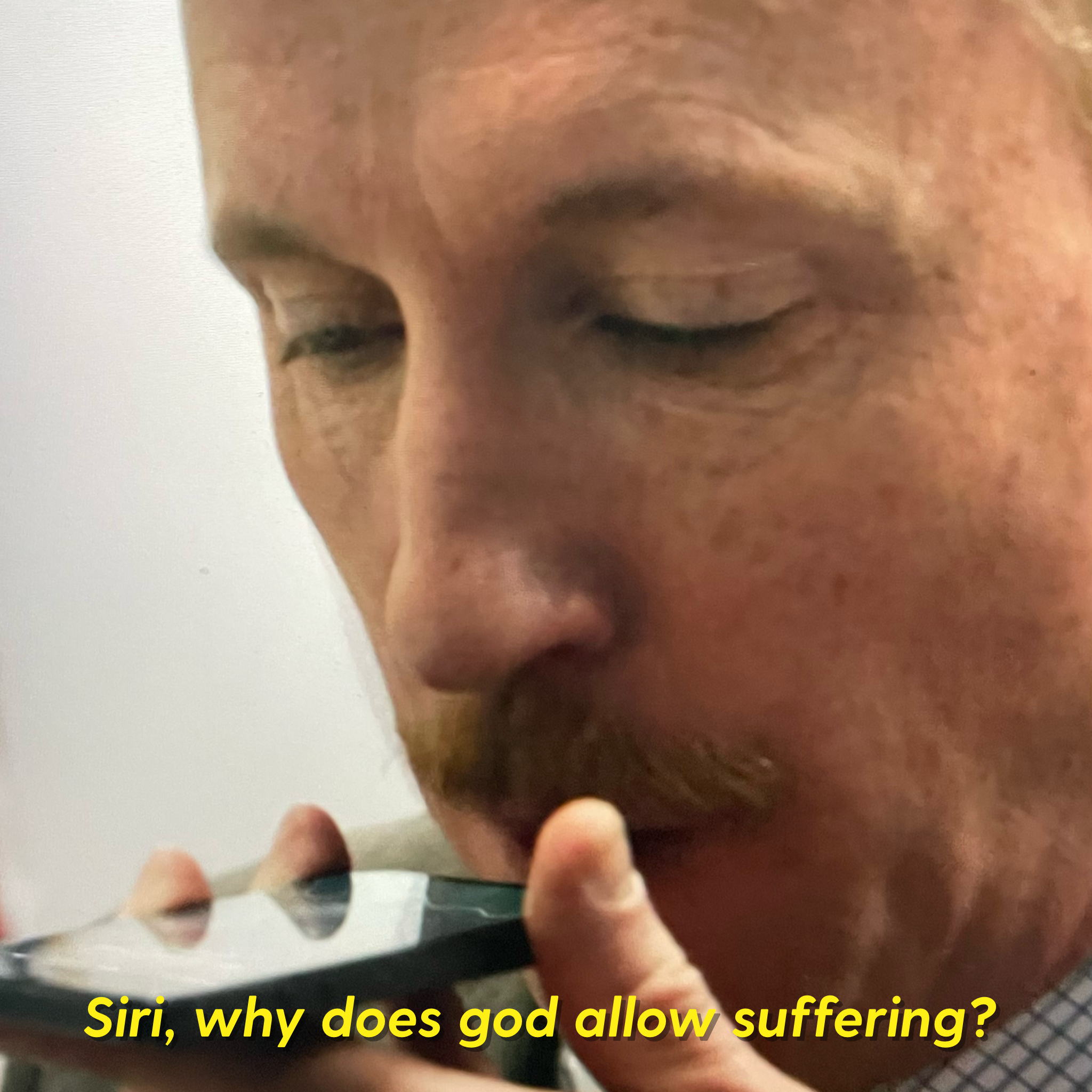 Guy talking into phone Siri why does god allow suffering