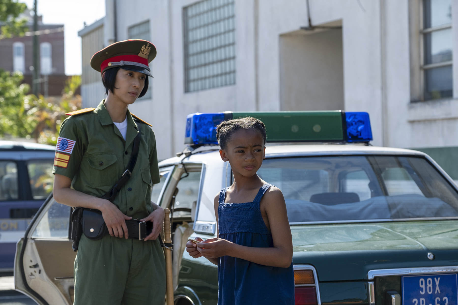 child and cop next to cop car in Korea