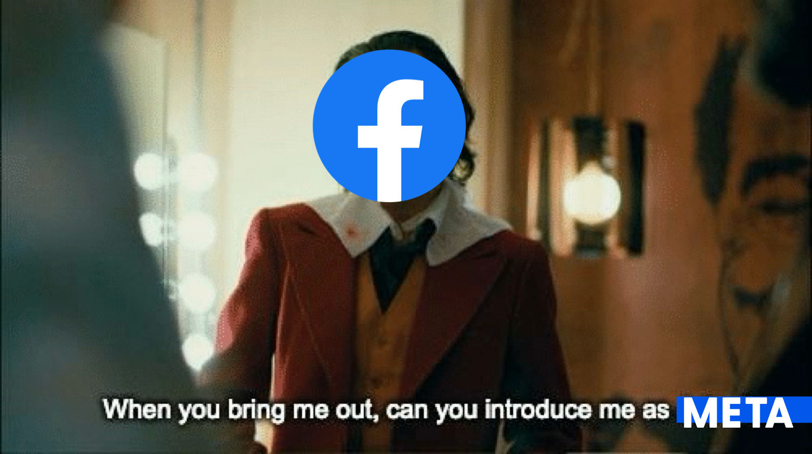 Movie still from Joker with the Facebook logo over jokers face. Caption reads when you bring me out can you introduce me as Meta