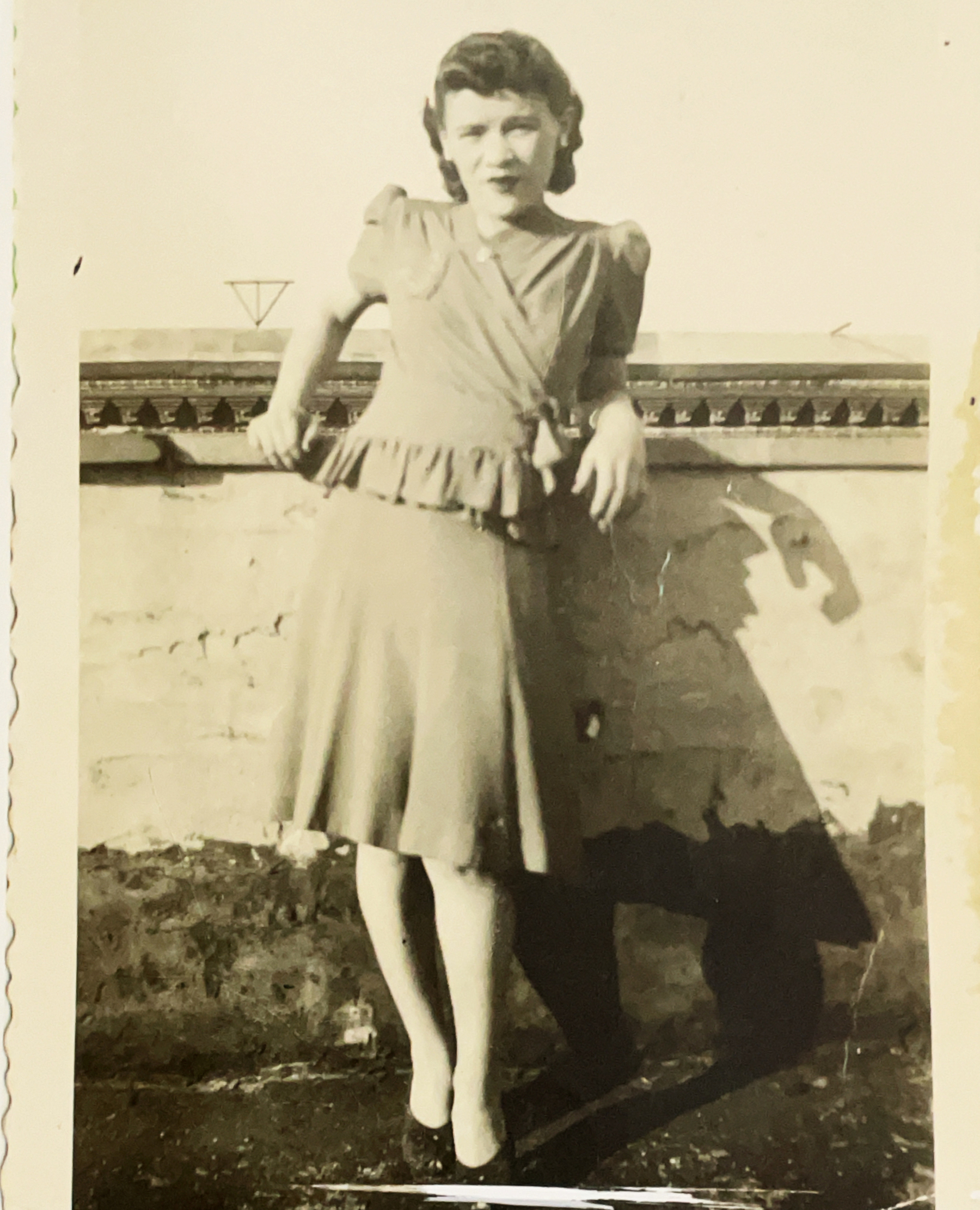 Young women on the roof of a building in a dress. Black and white photo. 