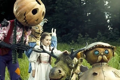 Photo of Dorothy with a moose, a robot, and a pumpkin character   