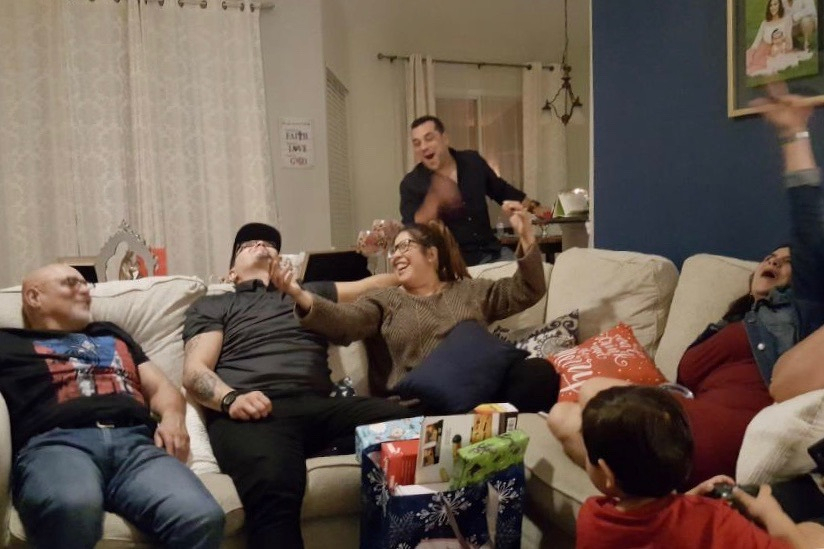 Photo of my family sitting on a couch, all laughing and screaming. 